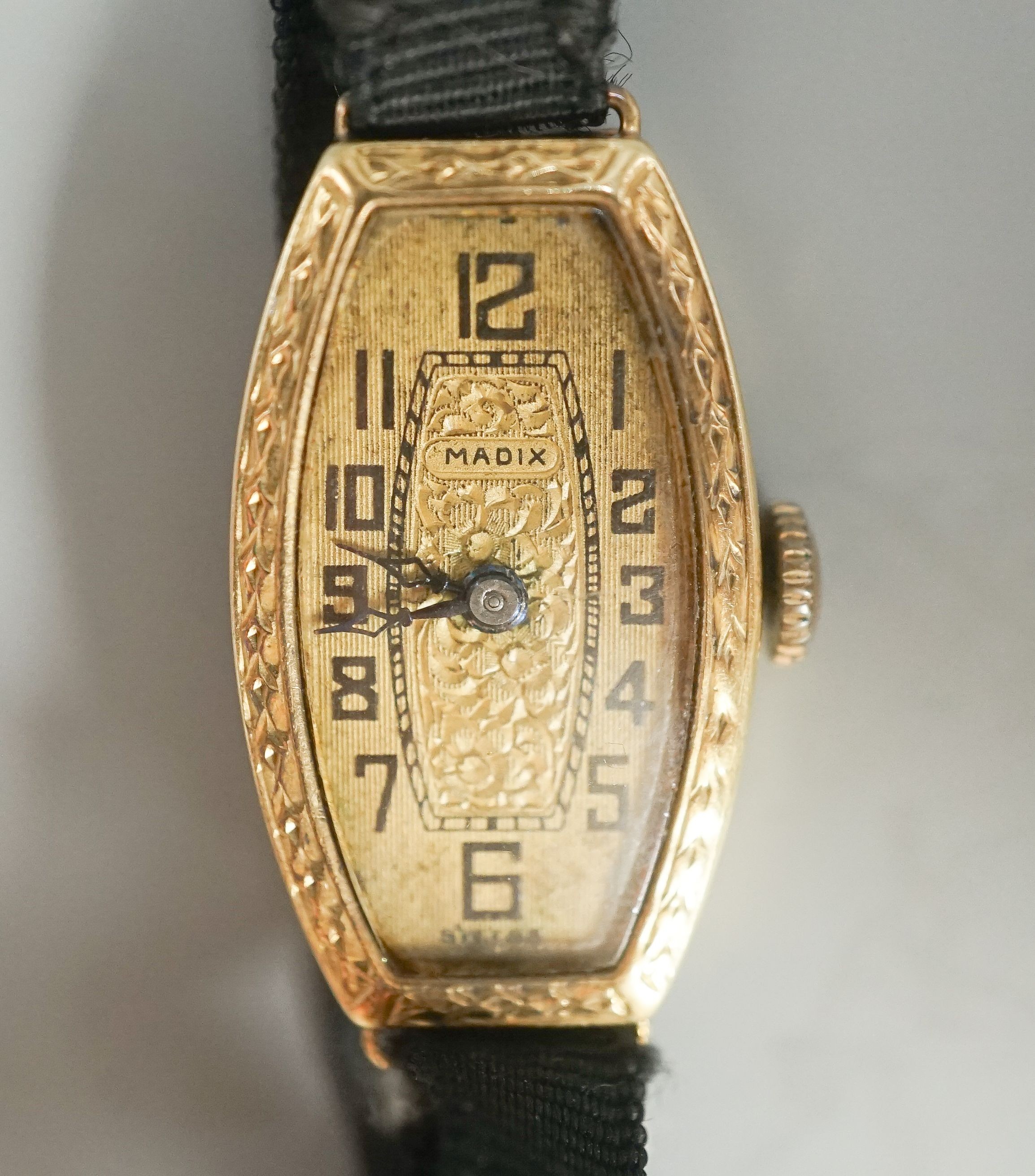 A lady's early 20th century 18ct gold manual wind wrist watch, case diameter 17mm, on a sash strap with 9ct buckle